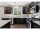 Kitchen featuring dark cabinets, granite countertops, and stainless steel appliances at 3750 Thackary Dr, Powder Springs, GA 30127