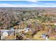 An aerial view of a house and lot with surrounding mature trees on a sunny day at 6045 Mockingbird Rd, Cumming, GA 30028