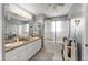 Bright bathroom featuring double sinks, shower-tub, neutral color scheme, and ample counter space at 6045 Mockingbird Rd, Cumming, GA 30028