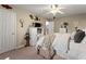 Bright bedroom with a ceiling fan, carpet, and minimalist furniture at 6045 Mockingbird Rd, Cumming, GA 30028
