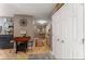 Inviting hallway with hardwood floors, coat closet, unique furniture, and warm, neutral paint at 6045 Mockingbird Rd, Cumming, GA 30028
