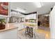 The bright kitchen is open, has white cabinets, stainless appliances, and a butcher block island at 6045 Mockingbird Rd, Cumming, GA 30028