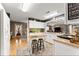 Bright kitchen featuring white cabinets, a butcher block island, and hardwood floors at 6045 Mockingbird Rd, Cumming, GA 30028