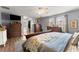 Comfortable main bedroom with hardwood floors, a ceiling fan, and view into the walk-in closet at 6045 Mockingbird Rd, Cumming, GA 30028
