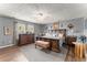 Spacious main bedroom featuring hardwood floors, stylish decor, large windows and a ceiling fan at 6045 Mockingbird Rd, Cumming, GA 30028