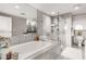 Elegant bathroom with a soaking tub and a glass-enclosed shower, all adorned with marble finishes at 700 Park Regency Ne Pl # 1407, Atlanta, GA 30326