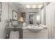 Traditional bathroom with white cabinets, marble countertops, and decorative lighting at 700 Park Regency Ne Pl # 1407, Atlanta, GA 30326