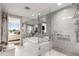 Modern bathroom featuring marble tile, a soaking tub, and a glass-enclosed shower at 700 Park Regency Ne Pl # 1407, Atlanta, GA 30326