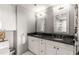 Well-lit bathroom with a double vanity, sleek fixtures, and a separate toilet area for added privacy at 700 Park Regency Ne Pl # 1407, Atlanta, GA 30326