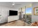 Cozy bedroom featuring a large window, dresser with a TV, and a serene view of the outdoors from a private balcony at 700 Park Regency Ne Pl # 1407, Atlanta, GA 30326