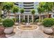 Beautiful front entrance with water feature, manicured landscaping, and modern architecture at 700 Park Regency Ne Pl # 1407, Atlanta, GA 30326