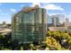 Elegant high-rise with curved balconies offering stunning city views, surrounded by lush landscaping at 700 Park Regency Ne Pl # 1407, Atlanta, GA 30326
