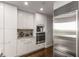 Modern kitchen with stainless steel appliances, including refrigerator and oven, plus white cabinets at 700 Park Regency Ne Pl # 1407, Atlanta, GA 30326