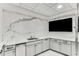 A stylish kitchenette features marble backsplash, white cabinetry, mini fridge, sink, and counter space at 700 Park Regency Ne Pl # 1407, Atlanta, GA 30326
