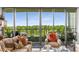 Cozy living room featuring comfortable seating, natural light from expansive windows, and a view of the lush greenery at 700 Park Regency Ne Pl # 1407, Atlanta, GA 30326