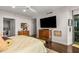 Well-lit main bedroom featuring hardwood floors, a large window, and comfortable furnishings at 700 Park Regency Ne Pl # 1407, Atlanta, GA 30326
