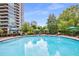 Large, sparkling pool surrounded by lounge chairs and umbrellas, perfect for relaxation and recreation at 700 Park Regency Ne Pl # 1407, Atlanta, GA 30326