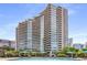 Exterior view of sparkling pool with lounge chairs, umbrellas, and high-rise building in the background at 700 Park Regency Ne Pl # 1407, Atlanta, GA 30326