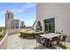 Outdoor terrace featuring lounge seating, outdoor dining, a built in fireplace, and city skyline views at 700 Park Regency Ne Pl # 1407, Atlanta, GA 30326