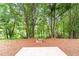 Backyard featuring a firepit and surrounding trees at 2155 Mindy Ln, Cumming, GA 30041