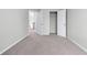 Bedroom features neutral walls, plush carpet, closet and ensuite bathroom at 2155 Mindy Ln, Cumming, GA 30041