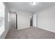 Bright bedroom featuring neutral walls, plush carpet, closet and ensuite bathroom at 2155 Mindy Ln, Cumming, GA 30041