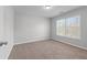 Spare bedroom with neutral carpeting, large window, and ample natural light at 2155 Mindy Ln, Cumming, GA 30041