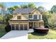Charming two-story home featuring a two-car garage, manicured lawn, and beautiful stone and siding accents at 2155 Mindy Ln, Cumming, GA 30041