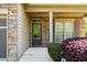 Inviting front porch with stone accents, leading to a stylish front door and charming window details at 2155 Mindy Ln, Cumming, GA 30041