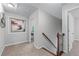 A spacious hallway with wood railings, framed artwork, and an open doorway at 2155 Mindy Ln, Cumming, GA 30041