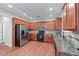 Spacious kitchen with wooden cabinets, stainless steel appliances, and granite countertops, ideal for cooking and dining at 2155 Mindy Ln, Cumming, GA 30041