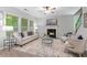 Cozy living room with fireplace, plush seating, and natural light, creating a comfortable gathering space at 2155 Mindy Ln, Cumming, GA 30041