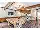 Basement recreation area features a pool table, bar, and wood beamed ceilings at 2682 Boulder Creek Ne Dr, Roswell, GA 30075