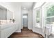 Modern bathroom with floating vanity, hardwood floors, and large windows at 2682 Boulder Creek Ne Dr, Roswell, GA 30075