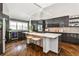 Stunning kitchen with dark wood cabinets, large kitchen island with white countertop, and barstool seating at 2682 Boulder Creek Ne Dr, Roswell, GA 30075