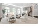 Inviting living room featuring large windows, comfortable seating, and an open floor plan at 2682 Boulder Creek Ne Dr, Roswell, GA 30075