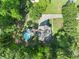 Aerial view of property showing the house, pool, deck, driveway and surrounding mature trees at 411 Hollis Cir, Dallas, GA 30157