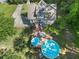 Aerial view of a home highlighting a large deck, swimming pool, lush backyard, and extended driveway at 411 Hollis Cir, Dallas, GA 30157