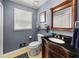 Charming bathroom features a vanity with dark granite countertop and stylish mirror at 411 Hollis Cir, Dallas, GA 30157