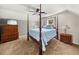 Bedroom with a four poster bed, a blue quilt, dresser and a window offering natural light at 411 Hollis Cir, Dallas, GA 30157