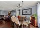 Well-lit dining room featuring hardwood floors, stylish light fixture, and ornate wall decorations at 411 Hollis Cir, Dallas, GA 30157