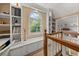 Hallway with charming decor, built-in shelves and a sunlit window seat with backyard view at 411 Hollis Cir, Dallas, GA 30157