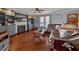 Spacious living room featuring a fireplace with built-in shelves, hardwood floors, and large windows at 411 Hollis Cir, Dallas, GA 30157