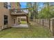 Backyard featuring a wood fence, mature trees, and a deck overlooking the yard at 4567 Hickory Forest Nw Dr, Acworth, GA 30102