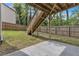 Backyard with concrete patio area, wooden fence, and under deck support at 4567 Hickory Forest Nw Dr, Acworth, GA 30102