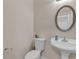 Cozy powder room features a pedestal sink and an oval mirror at 4567 Hickory Forest Nw Dr, Acworth, GA 30102