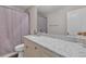 Bathroom showcasing a granite countertop vanity and shower with decorative curtain at 4567 Hickory Forest Nw Dr, Acworth, GA 30102