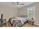 Neutral bedroom features a full-size bed, ceiling fan, and a side table at 4567 Hickory Forest Nw Dr, Acworth, GA 30102