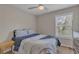 Comfortable bedroom with a queen-size bed, ceiling fan, and natural light at 4567 Hickory Forest Nw Dr, Acworth, GA 30102