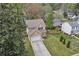 Aerial view showcases a two-story home with well-manicured lawn and tree-lined street at 4567 Hickory Forest Nw Dr, Acworth, GA 30102